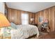 Traditional bedroom with wood paneled walls, neutral carpeting, and window at 6001-5742 S Kings Hwy., Myrtle Beach, SC 29575