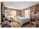 Cozy bedroom features wood paneled walls, plush carpeting, and serene natural light at 6001-5742 S Kings Hwy., Myrtle Beach, SC 29575