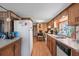 Open concept kitchen with wood paneling, standard appliances, laminate counters, and wood-look flooring at 6001-5742 S Kings Hwy., Myrtle Beach, SC 29575