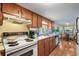 A functional kitchen boasts wood cabinetry, a double basin sink, and a cozy dining area at 6001-5742 S Kings Hwy., Myrtle Beach, SC 29575