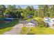 Aerial view of a charming home with a covered porch, surrounded by mature trees and lush lawn at 64 Highway 521, Andrews, SC 29510
