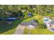 Aerial view of a well-maintained property with a long driveway, lush lawn, and mature trees at 64 Highway 521, Andrews, SC 29510