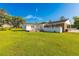 Expansive backyard with well-maintained lawn and rear view of the home with white siding and brick accents at 64 Highway 521, Andrews, SC 29510