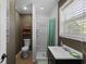 Cozy bathroom featuring a single sink vanity, shower, and shelving at 64 Highway 521, Andrews, SC 29510