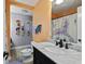 Colorful bathroom featuring a marble top vanity and an adjacent stool with natural light at 64 Highway 521, Andrews, SC 29510