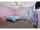Cozy bedroom featuring pink walls, carpet, a dollhouse, and great natural light at 64 Highway 521, Andrews, SC 29510