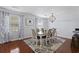 Elegant dining room with a chandelier, hardwood floors, and a large window at 64 Highway 521, Andrews, SC 29510