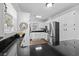 Bright kitchen with white cabinetry, stainless steel appliances, and black countertops at 64 Highway 521, Andrews, SC 29510