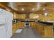 Modern kitchen boasts wood paneled walls, black countertops, and stainless steel appliances at 64 Highway 521, Andrews, SC 29510