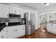 Modern kitchen featuring stainless steel appliances, white cabinets, and black countertops at 64 Highway 521, Andrews, SC 29510
