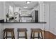 Modern kitchen featuring stainless steel appliances, black countertops, and stylish bar seating at 64 Highway 521, Andrews, SC 29510