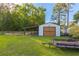 Exterior view of a metal outbuilding with a lean-to and wood doors at 64 Highway 521, Andrews, SC 29510