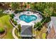 Aerial view of the heart-shaped pool, fence, pool furniture and nearby building at 682 Riverwalk Dr. # 102, Myrtle Beach, SC 29579