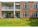 Exterior showing grass and the back of the building. Features a patio with chairs and awning at 682 Riverwalk Dr. # 102, Myrtle Beach, SC 29579