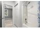 Bathroom showing shower/tub combo with white surround and a view of the bedroom at 682 Riverwalk Dr. # 102, Myrtle Beach, SC 29579
