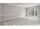 Bedroom with neutral carpet, arched window, and white trim at 682 Riverwalk Dr. # 102, Myrtle Beach, SC 29579