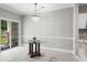 Dining area with a sliding glass door to the balcony, modern chandelier, and updated paint at 682 Riverwalk Dr. # 102, Myrtle Beach, SC 29579