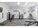 Well-equipped fitness center featuring modern exercise machines, carpeted floors, and natural light from large windows at 682 Riverwalk Dr. # 102, Myrtle Beach, SC 29579