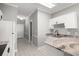 Kitchen with granite counters, white cabinets, and sleek, modern fixtures at 682 Riverwalk Dr. # 102, Myrtle Beach, SC 29579