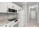 Modern kitchen with stainless steel appliances, granite countertops, and white cabinetry at 682 Riverwalk Dr. # 102, Myrtle Beach, SC 29579
