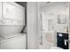 Laundry room with stacked washer and dryer and view of bathroom with shower/tub combo at 682 Riverwalk Dr. # 102, Myrtle Beach, SC 29579