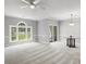 Living room featuring neutral carpet, large window, and modern chandelier at 682 Riverwalk Dr. # 102, Myrtle Beach, SC 29579