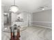 Bright, open living room featuring a modern chandelier and neutral decor at 682 Riverwalk Dr. # 102, Myrtle Beach, SC 29579