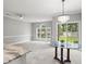 Sun-drenched living room with a glass table and large windows overlooking the backyard at 682 Riverwalk Dr. # 102, Myrtle Beach, SC 29579