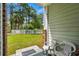 Exterior patio featuring two plastic chairs and a view of the grass and backyard at 682 Riverwalk Dr. # 102, Myrtle Beach, SC 29579