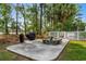 Outdoor picnic area featuring a concrete picnic table with benches, surrounded by mature trees and lush landscaping at 682 Riverwalk Dr. # 102, Myrtle Beach, SC 29579