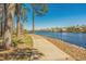 Scenic waterfront walkway with mature trees and lush landscaping, leading to beautiful waterfront homes at 682 Riverwalk Dr. # 102, Myrtle Beach, SC 29579