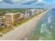 Expansive beach with beautiful ocean views, luxury resorts, and clear skies; ideal for relaxation and coastal enjoyment at 7000 N Ocean Blvd. # 427, Myrtle Beach, SC 29572