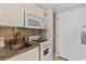 Efficient kitchen featuring white cabinets, appliances, and a compact design at 7000 N Ocean Blvd. # 427, Myrtle Beach, SC 29572