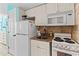 Efficient kitchen featuring white cabinets, appliances, and a compact design at 7000 N Ocean Blvd. # 427, Myrtle Beach, SC 29572