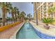 Inviting lazy river surrounded by lush palm trees and modern condos at 7000 N Ocean Blvd. # 427, Myrtle Beach, SC 29572