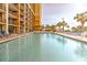 Resort-style pool with ample lounge chairs and palm trees, perfect for relaxation at 7000 N Ocean Blvd. # 427, Myrtle Beach, SC 29572