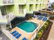 Beautiful outdoor swimming pool surrounded by blue lounge chairs and a colorful hotel at 7000 N Ocean Blvd. # 427, Myrtle Beach, SC 29572