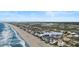 Breathtaking aerial view of oceanfront community with coastal homes, including 703 South Waccamaw Drive at 703 S Waccamaw Dr., Garden City Beach, SC 29576