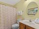 Well lit full bath with shower with tub combination, under sink vanity and white toilet at 703 S Waccamaw Dr., Garden City Beach, SC 29576