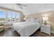 Bright bedroom with a king bed and three windows providing natural light and neighborhood views at 703 S Waccamaw Dr., Garden City Beach, SC 29576