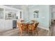 Bright dining area with stylish wicker chairs and built-in bar area with stainless steel appliances at 703 S Waccamaw Dr., Garden City Beach, SC 29576
