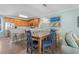 Open concept dining area with a kitchen breakfast bar and dining table that flows into the living room at 703 S Waccamaw Dr., Garden City Beach, SC 29576