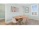 Bright dining room with modern table and chairs, stylish decor, and natural light at 703 S Waccamaw Dr., Garden City Beach, SC 29576