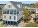 Coastal home with private balcony featuring a pool and ocean views, perfect for relaxation and entertaining at 703 S Waccamaw Dr., Garden City Beach, SC 29576