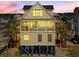 Stylish elevated home with a private balcony and pool offers stunning coastal living with beach proximity at 703 S Waccamaw Dr., Garden City Beach, SC 29576