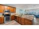 Kitchen with stainless steel appliances and granite countertops that transitions into the living area at 703 S Waccamaw Dr., Garden City Beach, SC 29576