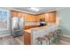 Bright kitchen featuring wooden cabinets, stainless steel appliances, and a breakfast bar with seating at 703 S Waccamaw Dr., Garden City Beach, SC 29576