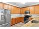 The kitchen features wooden cabinets, stainless steel appliances, and granite countertops at 703 S Waccamaw Dr., Garden City Beach, SC 29576
