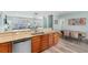 Open-concept kitchen featuring granite countertops, stainless appliances flowing into the living and dining areas at 703 S Waccamaw Dr., Garden City Beach, SC 29576