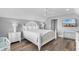 Bright main bedroom featuring a king bed, ceiling fan and a television for relaxing at 703 S Waccamaw Dr., Garden City Beach, SC 29576
